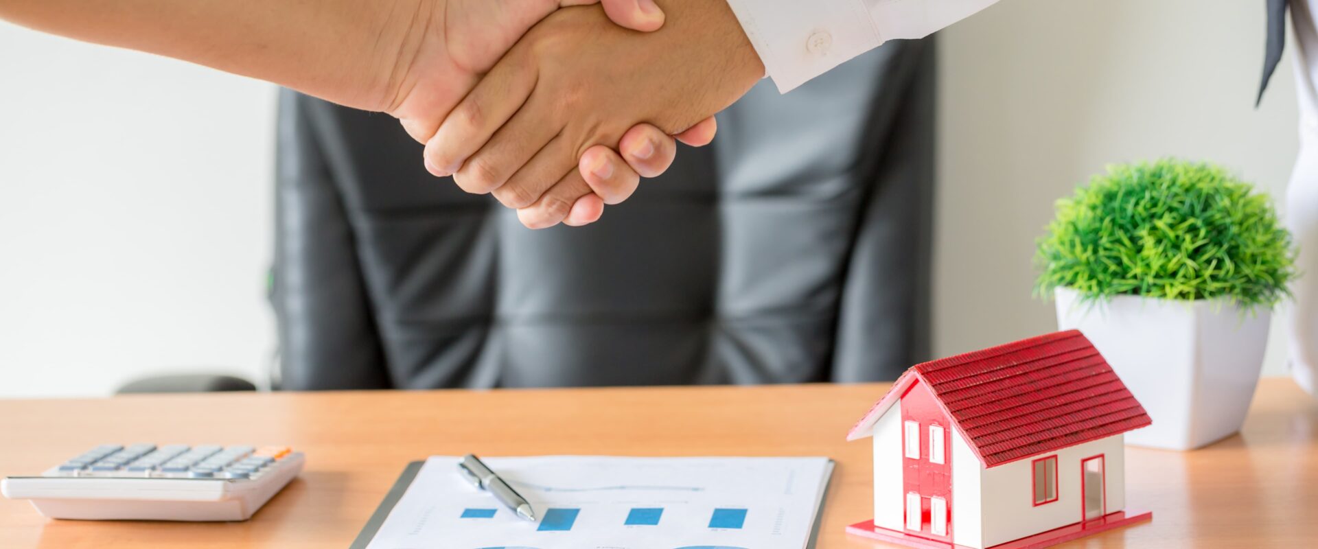Real estate consultant in Vadodara shaking hands with a client after a successful property consultation and agreement.