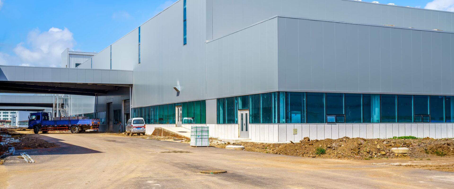 Modern industrial property in Vadodara featuring a large warehouse building with loading docks and commercial infrastructure.